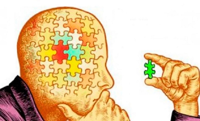 Man with puzzle head reflecting on a puzzle piece